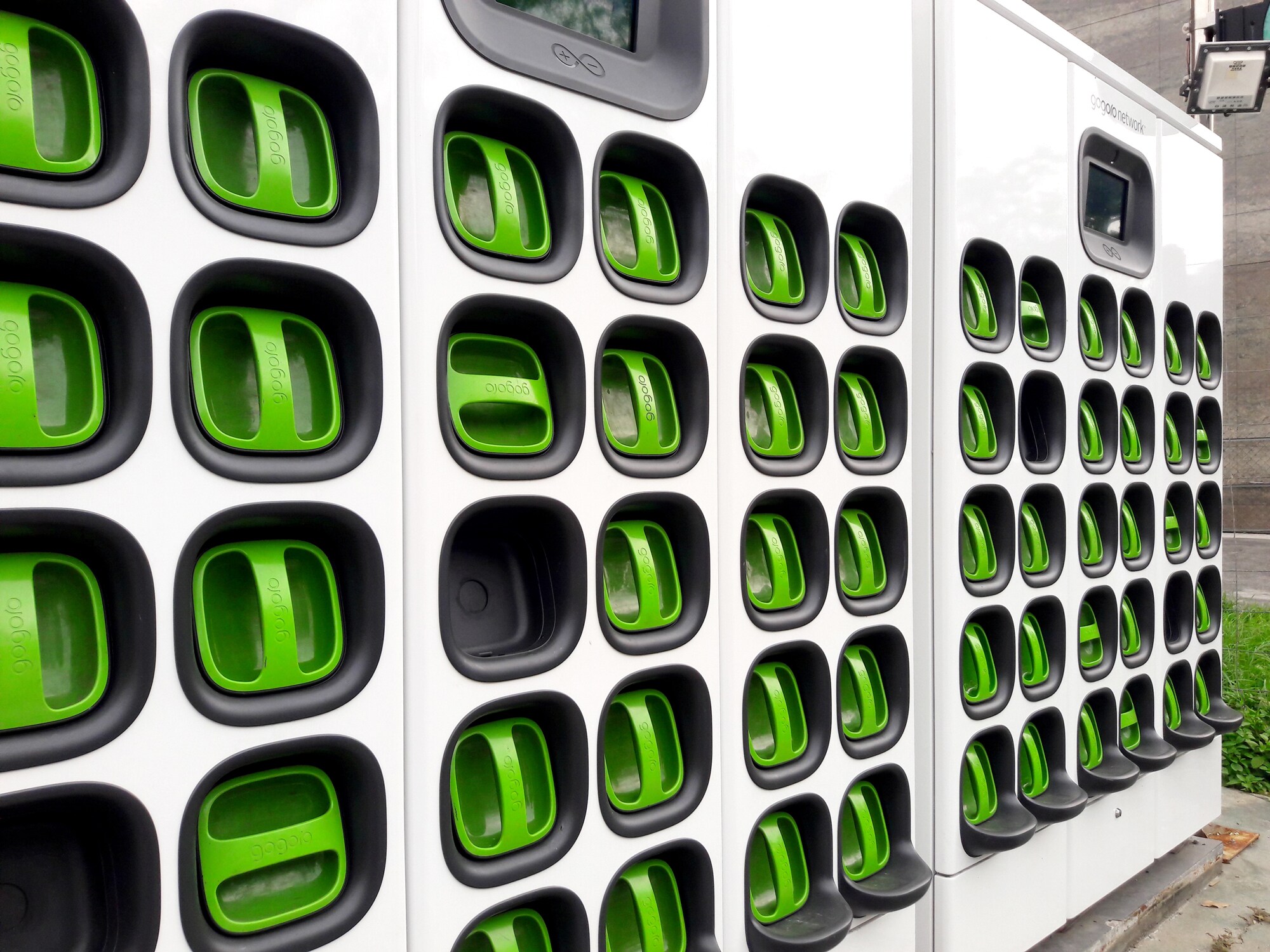 Figure 1: Batteries from Gogoro electric scooters can be removed, placed in the charging wall, and replaced by a fully charged battery.